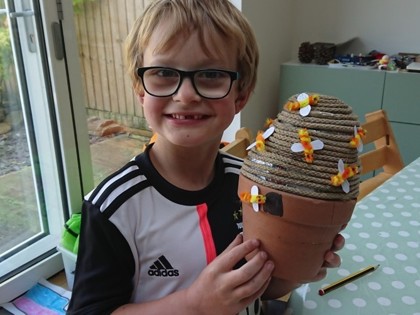 Reuben made a model beehive today. This afternoon he visited his Dad's beehives to look for the Queen bee, which he found 