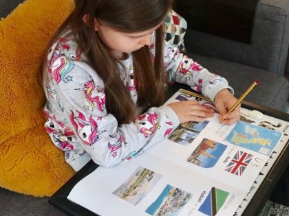 Sophia from Peake class worked hard on a giant poster for the themed learning about UK and Tanzania, also a poster about the shark facts. She's had fun with maths sums, enjoyed her reading in the garden and played with a newly built cardboard Grand Hotel.