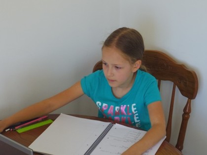 Diana has been watching her video lesson, working on her maths and her weather project.