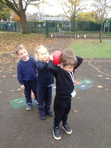 We've enjoyed practising ball skills in PE. We were passing the ball to our friends by rolling it or trying to pass it over and under. We also enjoyed balancing on some of the different sports equipment.